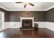 Cozy living room with fireplace, hardwood floors, and a ceiling fan at 194 Preston Nw Pl, Dallas, GA 30157