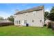 Large backyard with grass, trees, and wood fence at 5792 Village Loop, Fairburn, GA 30213