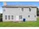 Grassy backyard with wood fence and mature shade trees at 5792 Village Loop, Fairburn, GA 30213
