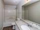 Bathroom offers a shower-tub combo, single sink vanity, and granite countertop at 5792 Village Loop, Fairburn, GA 30213