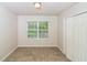 Carpeted bedroom with window and a closet at 5792 Village Loop, Fairburn, GA 30213