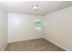 Carpeted bedroom offers neutral colors and a window at 5792 Village Loop, Fairburn, GA 30213