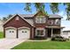 Charming brick two-story home with well-manicured lawn and a two-car garage at 5792 Village Loop, Fairburn, GA 30213