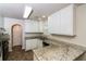 Well-lit kitchen offers ample cabinet space and granite counters at 5792 Village Loop, Fairburn, GA 30213