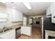 Bright kitchen with stainless steel appliances, granite counters, and open layout at 5792 Village Loop, Fairburn, GA 30213