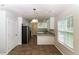 Well lit kitchen featuring tile flooring, stainless steel appliances and granite countertops at 5792 Village Loop, Fairburn, GA 30213