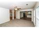 Inviting living room with ceiling fan, carpet, and a view of the kitchen at 5792 Village Loop, Fairburn, GA 30213