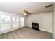 Spacious living room with a fireplace, carpet flooring, and ample natural light at 5792 Village Loop, Fairburn, GA 30213
