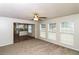 Bright living room featuring plush carpet, a ceiling fan and a view to kitchen at 5792 Village Loop, Fairburn, GA 30213