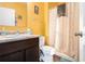 This bathroom featuring a shower-tub combination, single sink vanity, and yellow walls at 2126 Sawgrass Dr, Hampton, GA 30228