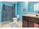 Bright blue bathroom featuring a shower-tub combination and stylish decor at 2126 Sawgrass Dr, Hampton, GA 30228