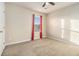This bedroom is well lit, with light beige carpet and light beige walls, perfect for relaxation at 2126 Sawgrass Dr, Hampton, GA 30228