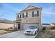 Attractive two-story home with brick facade, two car garage, and concrete driveway at 2126 Sawgrass Dr, Hampton, GA 30228