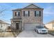 Charming two-story home with brick facade, a gray two-car garage, and manicured front yard at 2126 Sawgrass Dr, Hampton, GA 30228