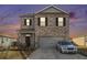 Charming two-story home with brick facade, a gray two-car garage, and manicured front yard at 2126 Sawgrass Dr, Hampton, GA 30228