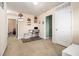 Hallway with neutral walls, carpet flooring, art decorations, and access to several rooms, including a desk area at 2126 Sawgrass Dr, Hampton, GA 30228