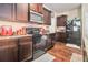 Functional kitchen featuring granite countertops, ample dark wood cabinetry, and black appliances for a cohesive look at 2126 Sawgrass Dr, Hampton, GA 30228