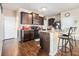 Spacious kitchen features dark wood cabinets, granite counters, island with bar stool seating, and stainless steel appliances at 2126 Sawgrass Dr, Hampton, GA 30228