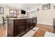 Kitchen island featuring dark wood cabinets, granite countertops, bar stool seating, with an open view to the living room at 2126 Sawgrass Dr, Hampton, GA 30228