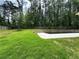 Expansive backyard featuring a well-maintained lawn, mature trees, and an inviting pool with a concrete deck at 464 Eager Ct, Marietta, GA 30064