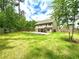 Large grassy backyard with a two-story home in the background and a wooden fence lining the perimeter of the property at 464 Eager Ct, Marietta, GA 30064