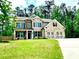 Charming two-story brick home featuring a well-manicured lawn, two-car garage and landscaped front yard at 464 Eager Ct, Marietta, GA 30064