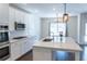 Well-lit kitchen features white cabinets, granite countertops, stainless appliances and ample counter space at 464 Eager Ct, Marietta, GA 30064