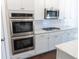 Well-equipped kitchen with stainless steel appliances, granite countertops, and white cabinets at 464 Eager Ct, Marietta, GA 30064
