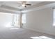 Spacious main bedroom with tray ceilings, recessed lighting, and abundant natural light from large windows at 464 Eager Ct, Marietta, GA 30064