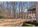 Large grassy backyard bordered by mature trees at 4520 Valence Dr, Cumming, GA 30040