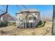 Beautiful home backyard featuring a deck, sunroom, well-maintained lawn, and lush landscaping at 4520 Valence Dr, Cumming, GA 30040