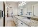 Bathroom features a double sink vanity with granite countertops and a large framed mirror at 4520 Valence Dr, Cumming, GA 30040