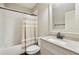 Well-lit bathroom with granite countertop, white cabinets and shower-tub combination at 4520 Valence Dr, Cumming, GA 30040