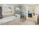 Bright bathroom with a glass enclosed shower, tub, and natural light from a window at 4520 Valence Dr, Cumming, GA 30040