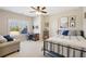Bedroom features neutral walls, a ceiling fan, natural light, a double bed, and a desk area at 4520 Valence Dr, Cumming, GA 30040