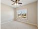 Empty bedroom featuring neutral walls, carpet, a ceiling fan, and natural light at 4520 Valence Dr, Cumming, GA 30040