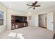 Spacious bedroom featuring a ceiling fan and large built-in entertainment center with ample storage at 4520 Valence Dr, Cumming, GA 30040
