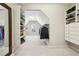 Large walk-in closet with organized shelving, clothing racks, and a mirror at 4520 Valence Dr, Cumming, GA 30040