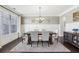 Well-lit dining room featuring a large window, dark hardwood floors, and an area rug under the table at 4520 Valence Dr, Cumming, GA 30040
