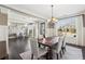 Bright dining room with dark hardwood floors, white curtains, and an adjacent sitting area at 4520 Valence Dr, Cumming, GA 30040