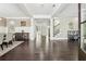 Bright entryway with dark hardwood floors, white columns, a staircase, and an adjacent dining area at 4520 Valence Dr, Cumming, GA 30040