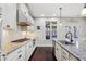 Gourmet kitchen with stainless steel appliances, granite counters and a sleek vent hood at 4520 Valence Dr, Cumming, GA 30040