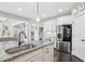 Bright open kitchen with granite counters, island with seating, and stainless steel appliances at 4520 Valence Dr, Cumming, GA 30040