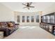 Large living room with comfortable seating, media center, carpet, and scenic windows at 4520 Valence Dr, Cumming, GA 30040