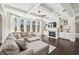 Spacious living room features fireplace, built-in shelving, ceiling fan, and expansive windows at 4520 Valence Dr, Cumming, GA 30040