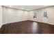 Neutral living room with dark hardwood flooring and a door with window insert leading to the outdoors at 4520 Valence Dr, Cumming, GA 30040