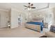Bright main bedroom boasts a tray ceiling, carpet, and ensuite bath access at 4520 Valence Dr, Cumming, GA 30040