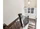 Staircase featuring hardwood steps and railing, a window with shutters and natural light at 4520 Valence Dr, Cumming, GA 30040