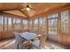 Enclosed sunroom with vaulted wood ceiling, fan, and outdoor views, perfect for relaxing or entertaining at 4520 Valence Dr, Cumming, GA 30040