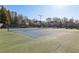 Community tennis courts and clubhouse surrounded by mature trees at 4520 Valence Dr, Cumming, GA 30040